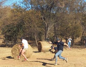 Men playing paintball on a farm