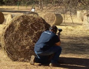 Men playing paintball on a farm